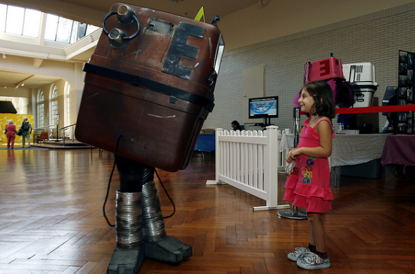 Angelica Nagara, 4, of Commerce Township is greeted by a Star Wars Gonk Droid, (Zach Miller, 9, of Monroe) at Maker Faire Detroit at The Henry Ford in Dearborn, Michigan. Saturday, July 28, 2012. (Gary Malerba for The Henry Ford)