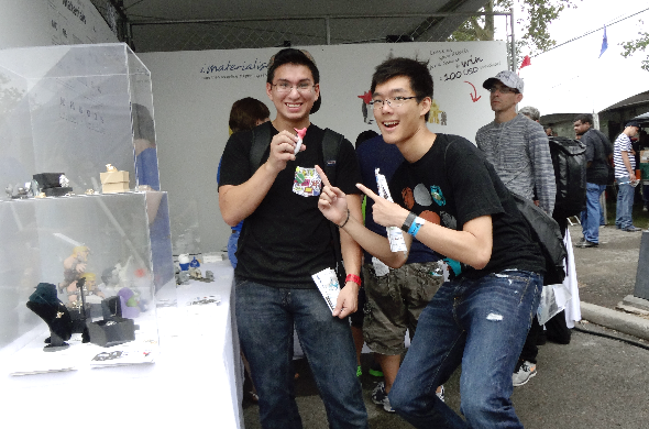 New York Maker Faire 2014: image of two young men smiling brightly in our booth, striking a finger-pointing pose