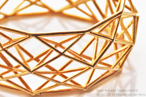 Photo of a golden colored brass bracelet by MCODE. This piece is called "Brass Bracelet Constructionist" by MCODE, courtesy of Maaike van der Horn.