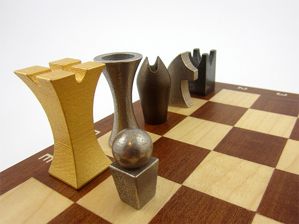 Chess set by Jonny Anthony. From front to rear: Gold Plated (left), Old silver (right), Old silver, Wheat Penny, Old silver, and Medieval Pewter