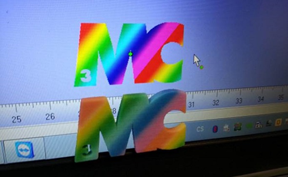 Example of a 3D print in multicolor and a bright computer screen.