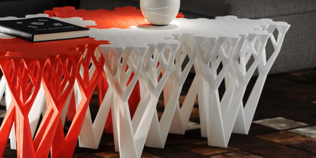A modular orange and white 3D-printed table.