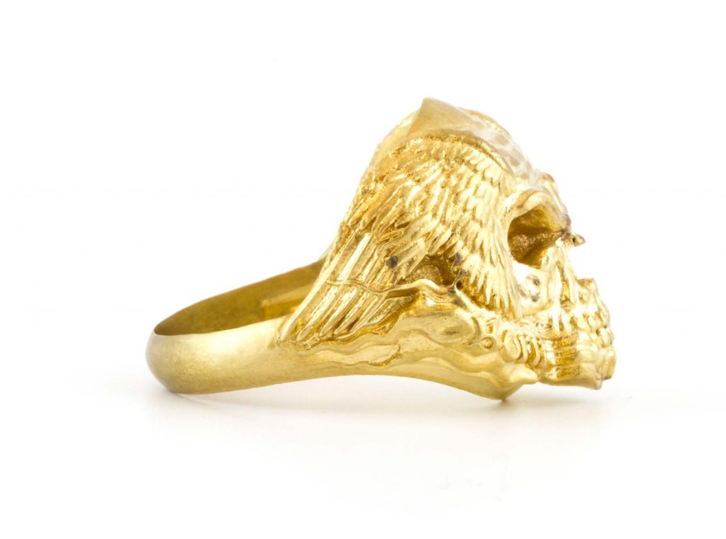 A 3D-printed ring made of gold with eagle wings.