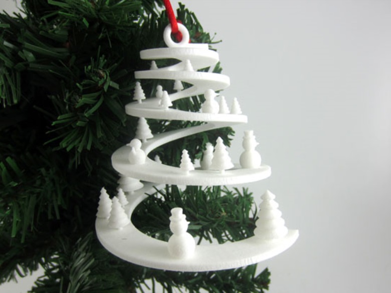 A white 3D-printed cone with snowmen on a Christmas tree branch.