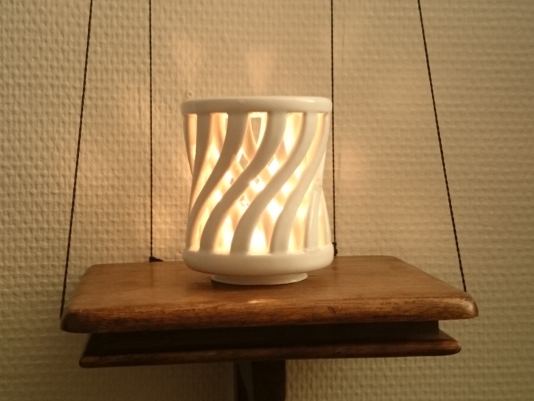 Lit by tea candle, white ceramics.